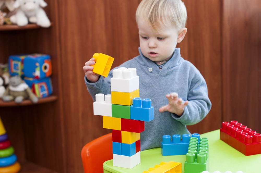 little kid play with blocks