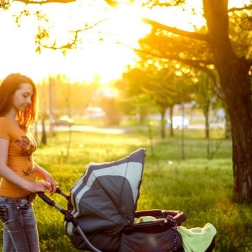 mother alone with stroller in park
