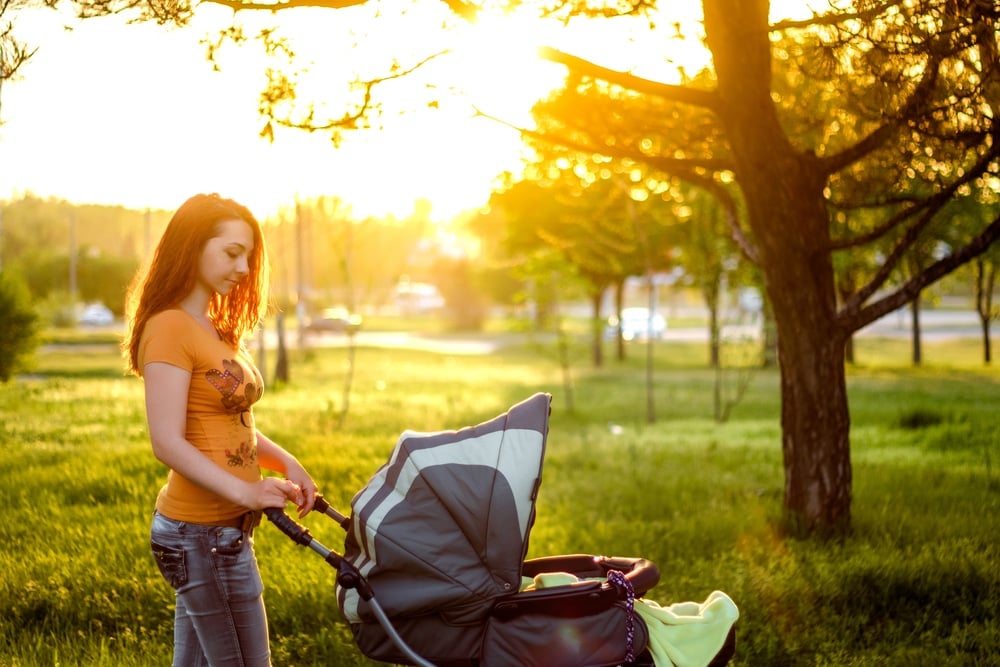 mother alone with stroller in park