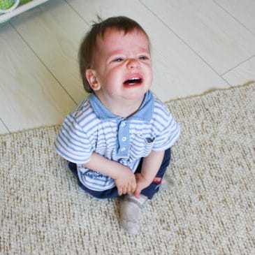 toddler crying on the floor
