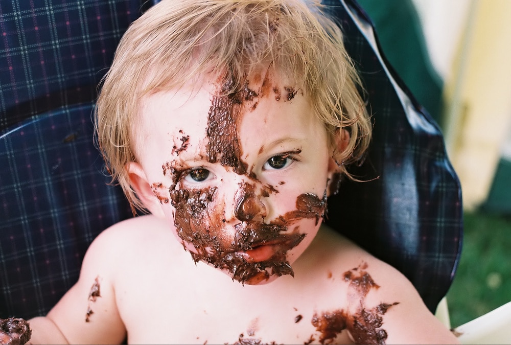 little boy with chocolate in his face