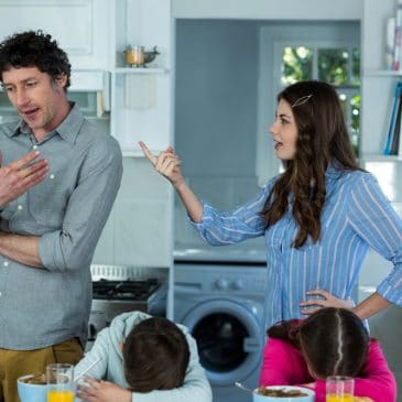 unhappy mother with father and kids in kitchen