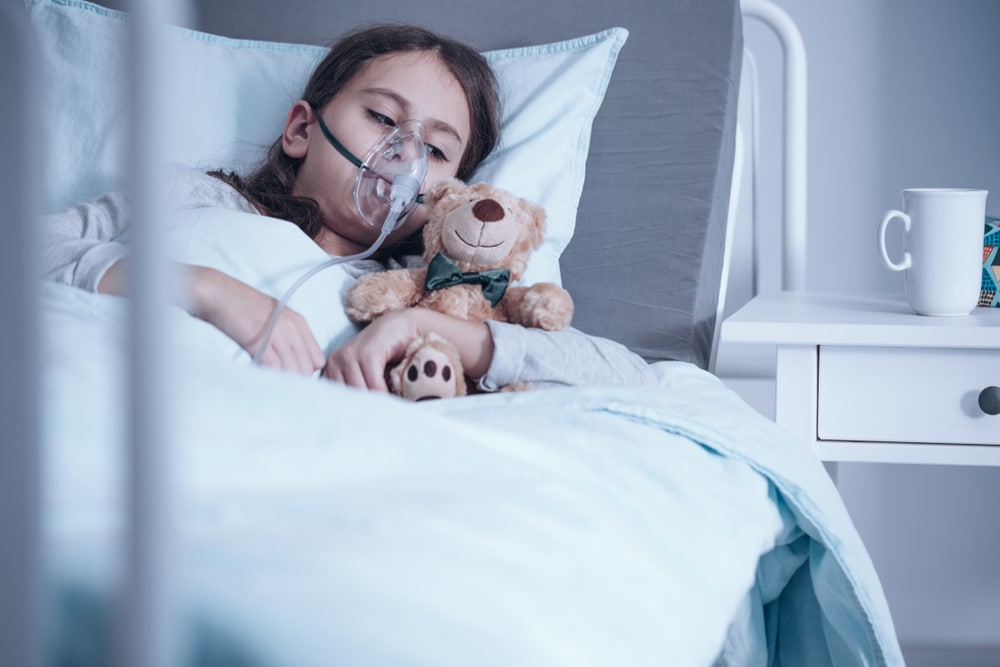 kid sick on hospital bed