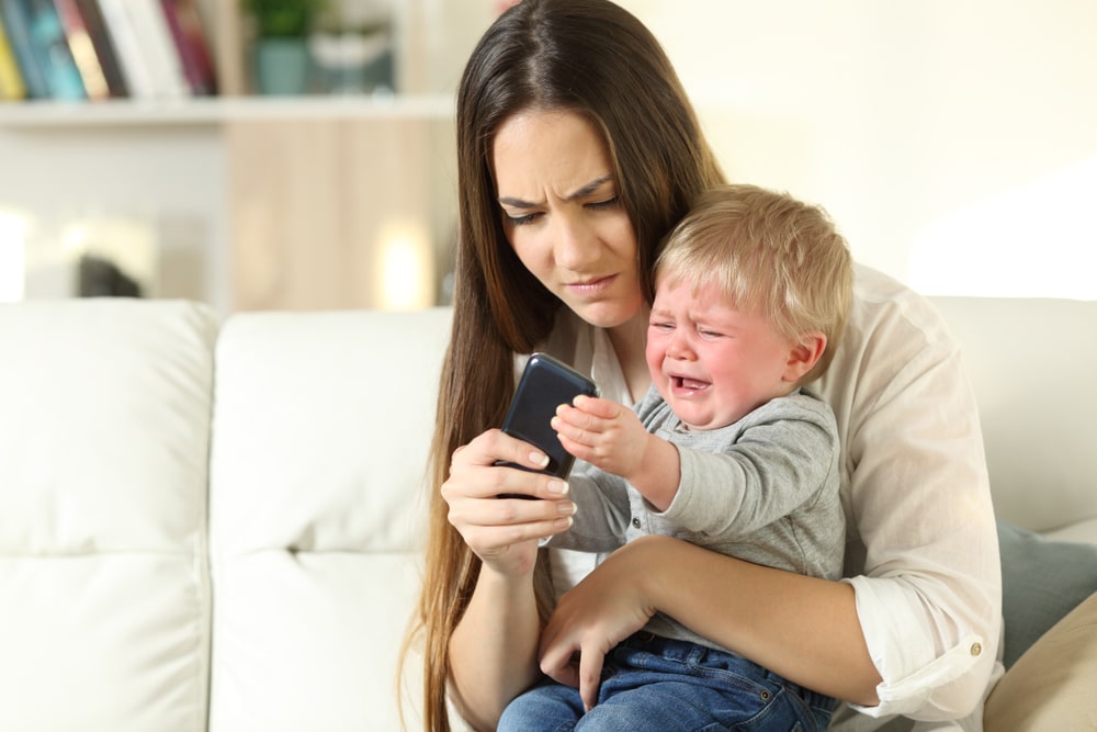 mother with kid angry cellphone