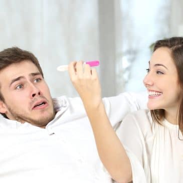 woman holding pregnancy test with scary man