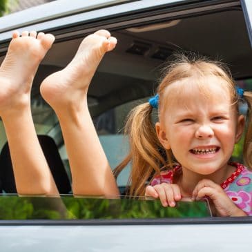two happy kids in a car