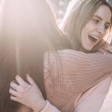 two women friends hug