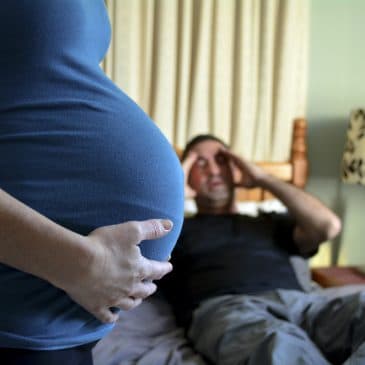pregnant woman with unhappy man