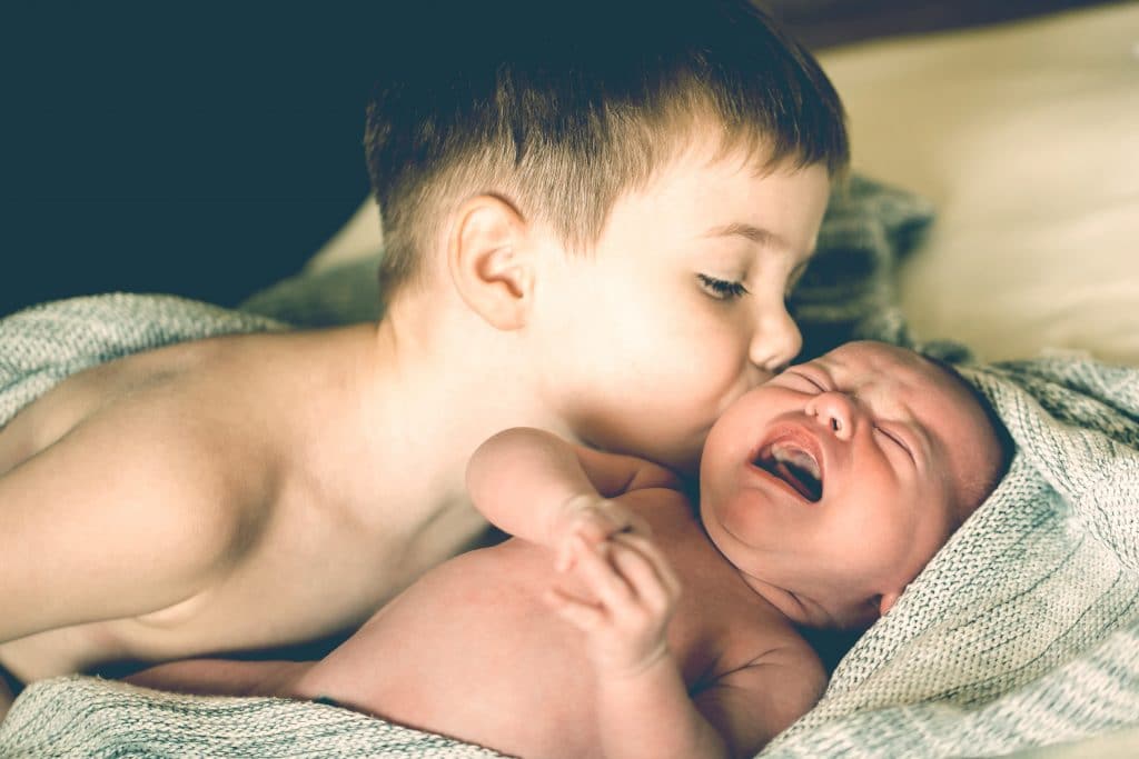 brother kiss newborn