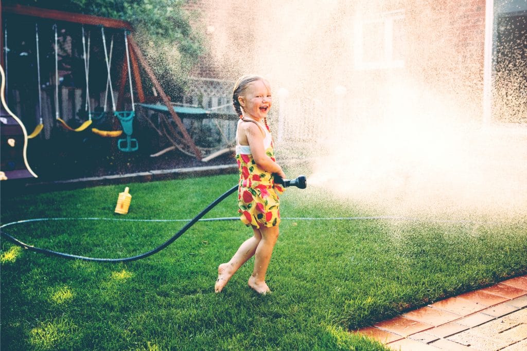 little girl play with hose