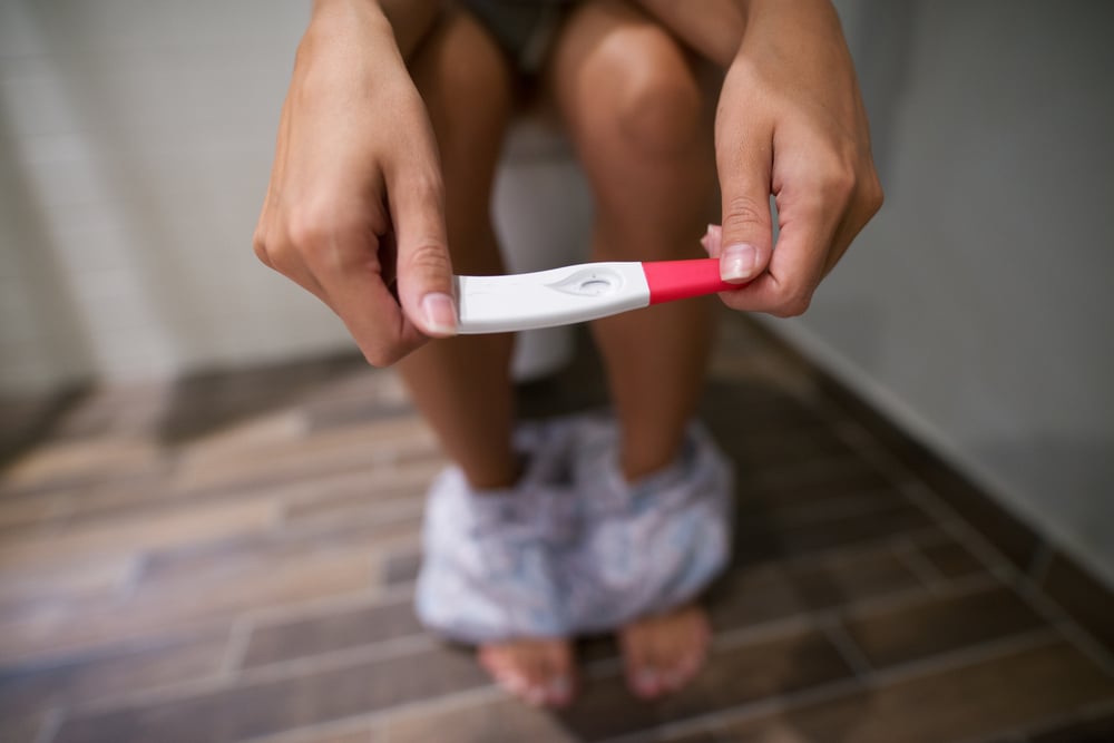 woman with pregnancy test