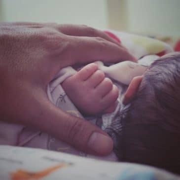 newborn with mother's hand