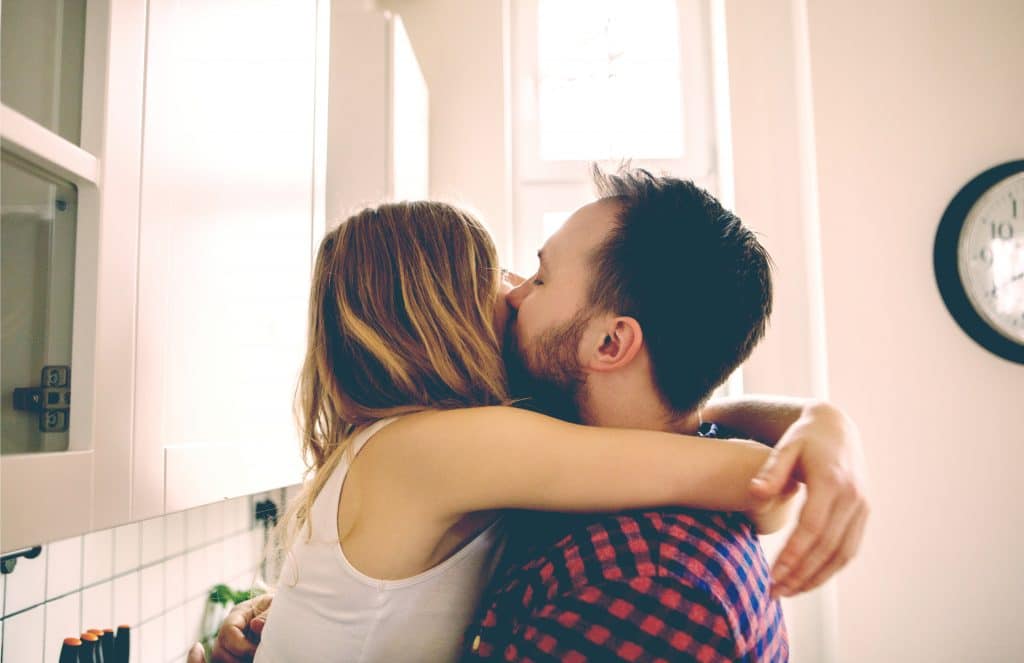 couple kiss in kitchen