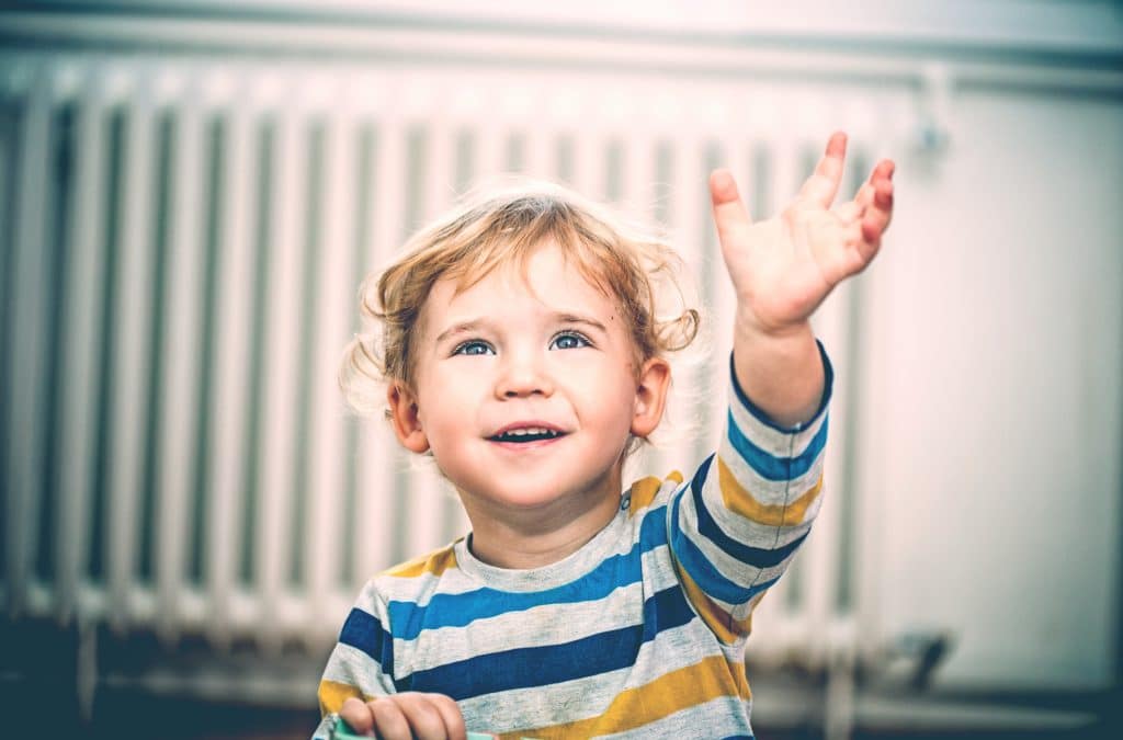 little boy waving