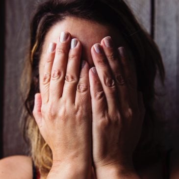 woman cry with face in hands
