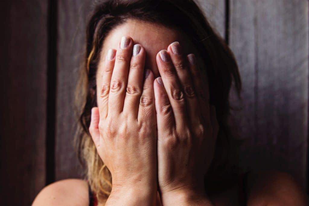 woman cry with face in hands