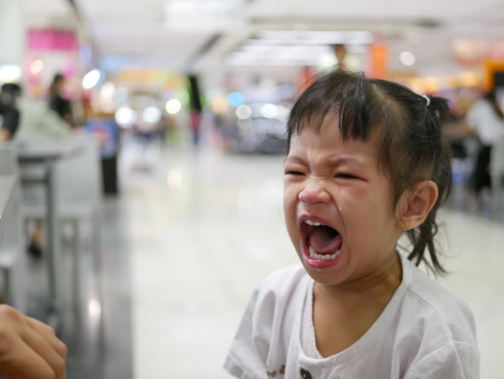 angry little girl at shopping center