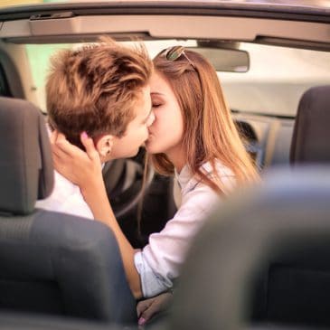 teens kissing in a car