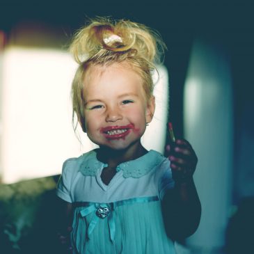 little girl with make up smile