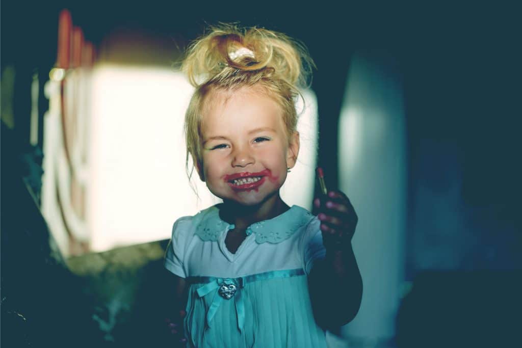 little girl with make up smile