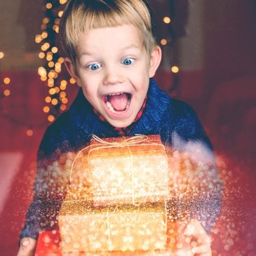 excited kid with xmas gifts