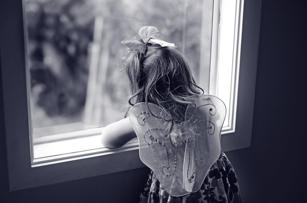 sad girl looking at window