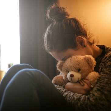 sad woman with teddy bear