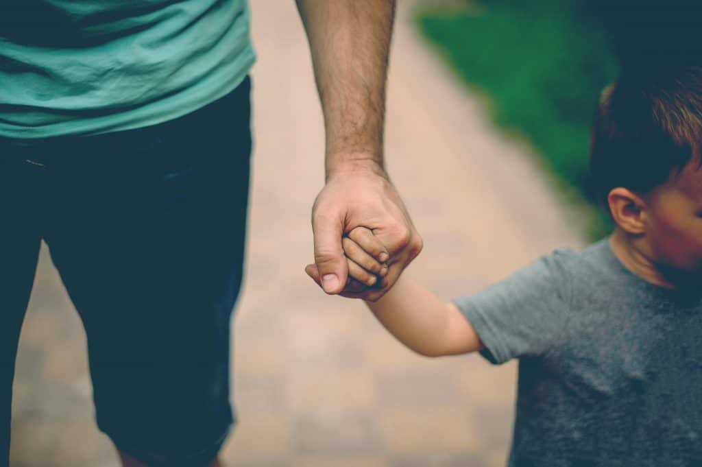 father hold kid's hand