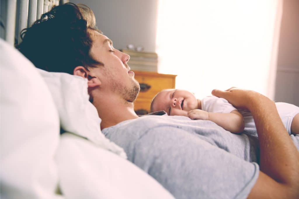 father sleeping with baby