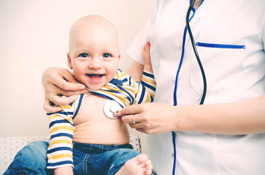little boy smiling with nurse