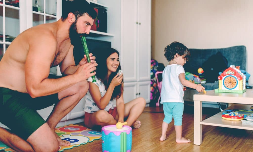 man play with kids in living room
