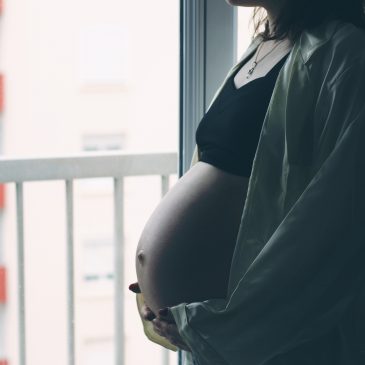 pregnant woman in front of window