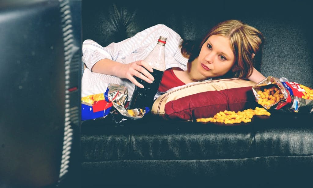 woman eat junk in living room