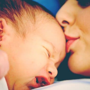 mother kiss newborn at hospital