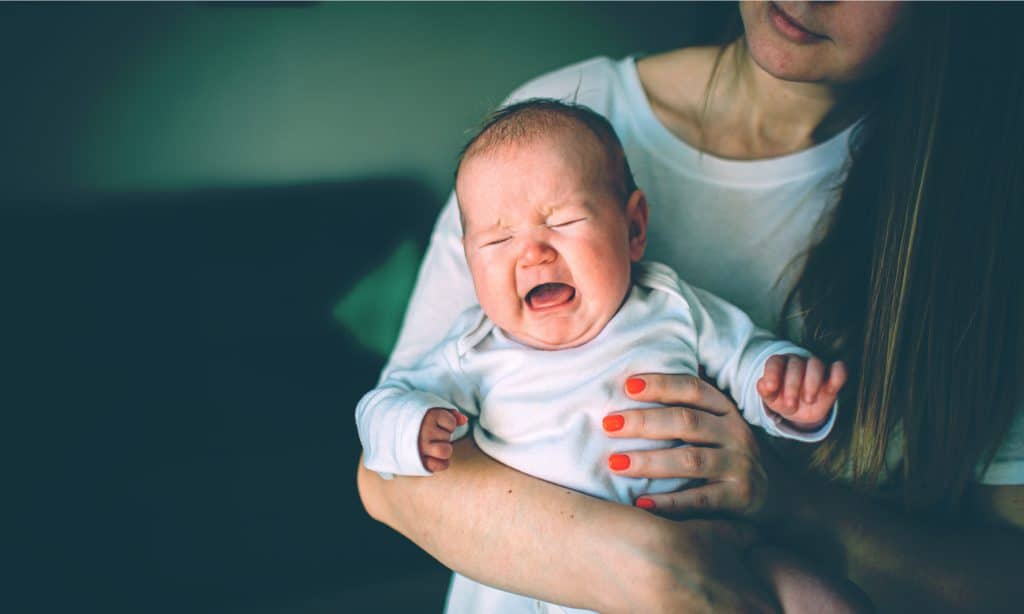 woman with baby crying