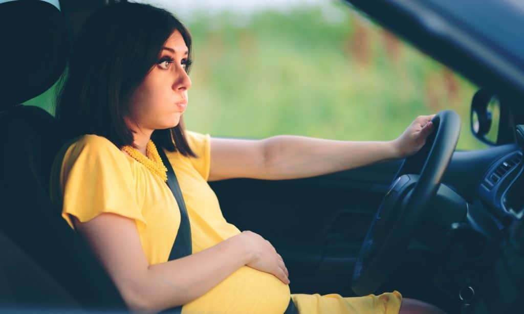 annoyed woman pregnant in a car