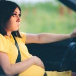 annoyed woman pregnant in a car