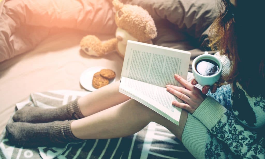 woman read book in bed