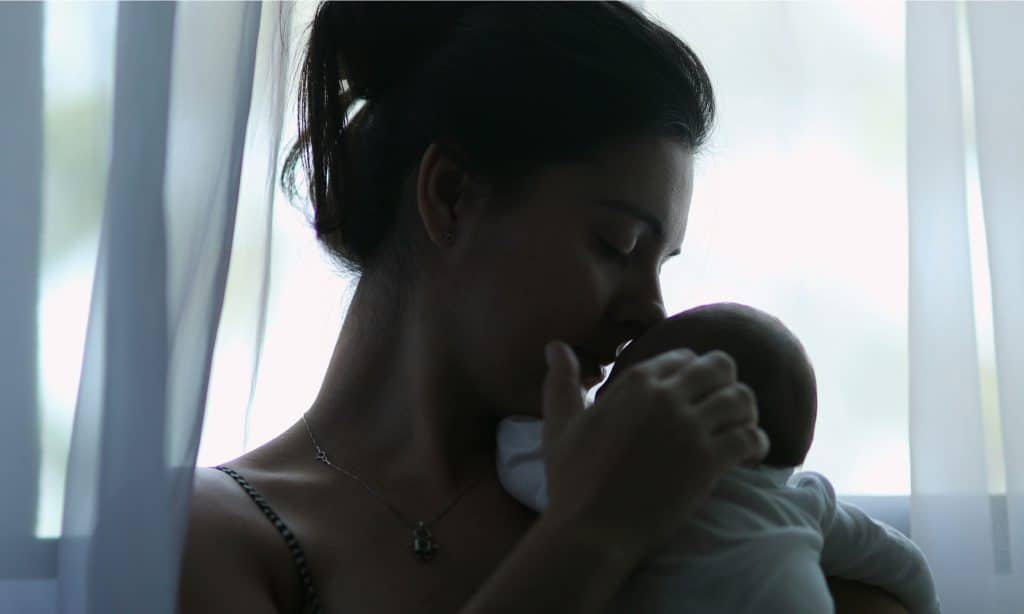 mother kiss newborn