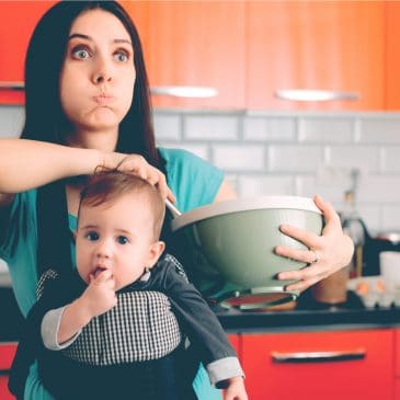 tired mother with baby in kitchen
