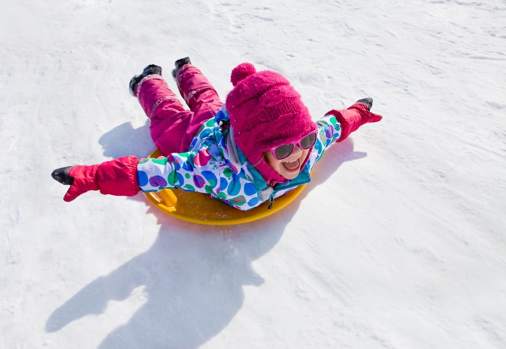 Little,Girl,Riding,On,Snow,Slides,In,Winter,Time