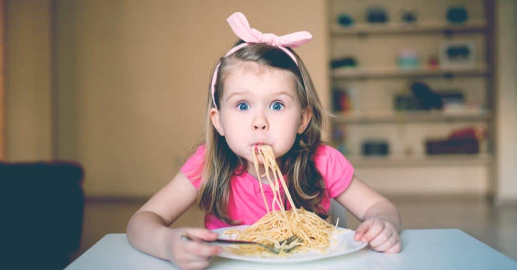 little girl eat spaghetti