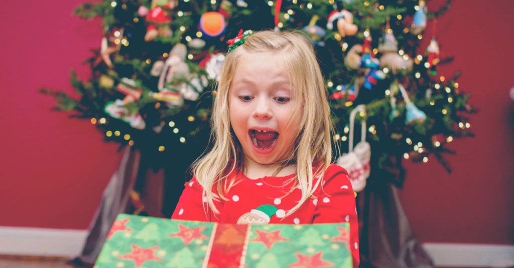 surprised kid opening gift
